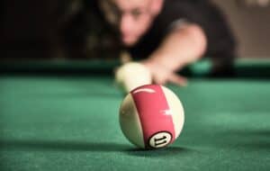 A pool player lining up a shot. Used in the article, Why Introverts are Great bloggers, in relation to focus