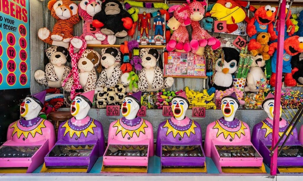 A photo of a clown heads on a ball machine at a fair. Used in the article Is there a Demand for Event Planners.