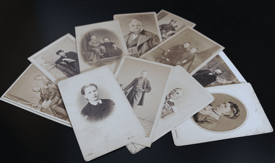 A set of 10 old photos showing people in past eras laid out in a fan pattern,  used in the article Is a Genealogy Course Necessary to Make Family Trees? 