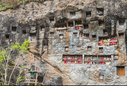 Tau Tau sculptors on the balcony of a cave in Tana Toraja Indonesia. Used in the article Death and dying in Torajan culture
