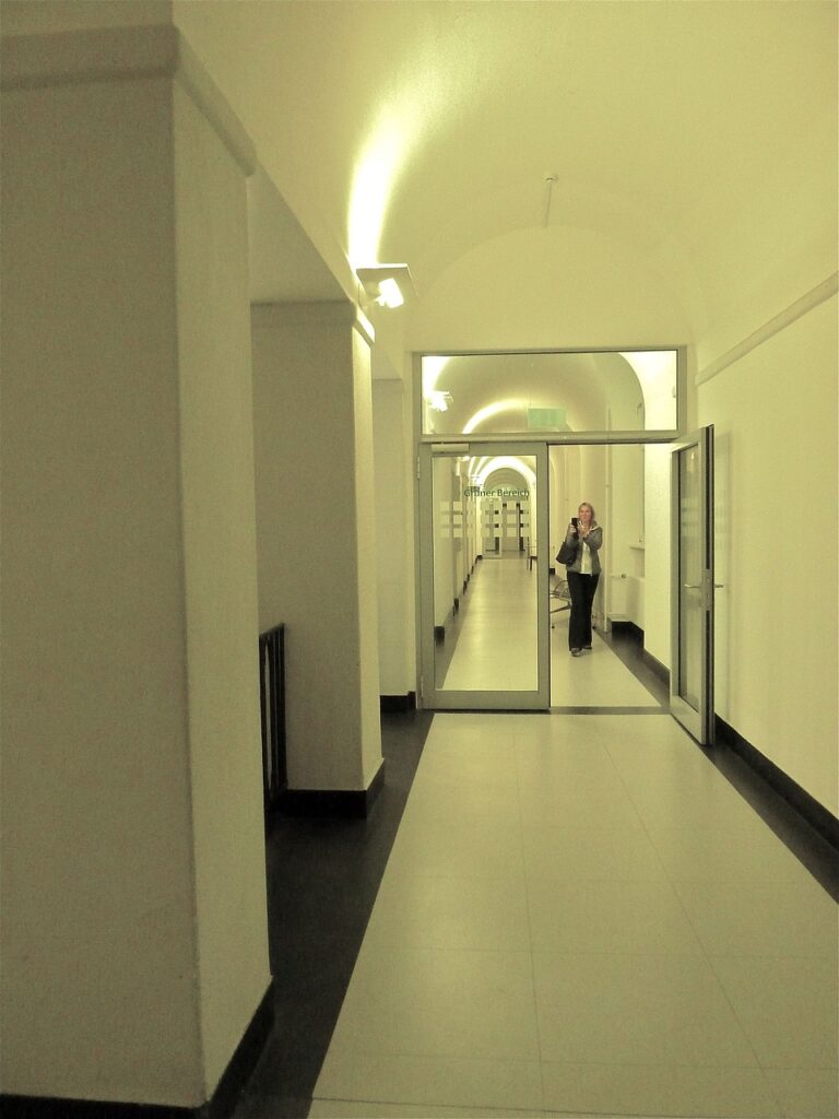 A woman walking along a hallway looking for an office. Used in the article How to open a bakery.