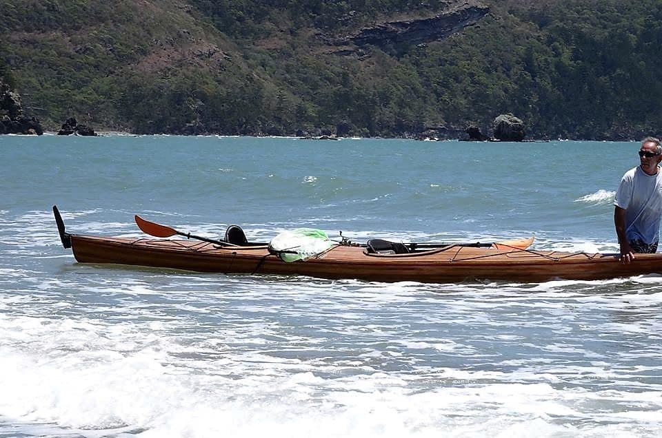 Me holding my 20ft double kayakat the beach waiting for my friend to come back with the fishing rods. Used in the article Learning Affiliate Marketing.