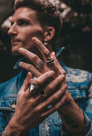 A photo of Oliver Proudlock. showing jewelry on his fingers. Used in the article, How to Master the Dropshipping Game.