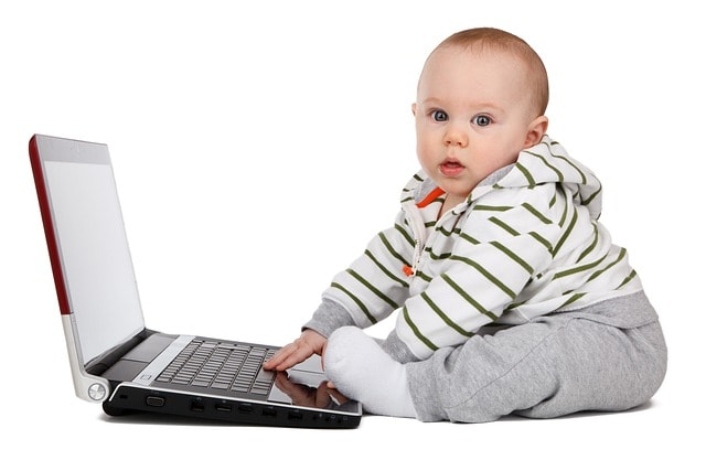A baby at  a computer.